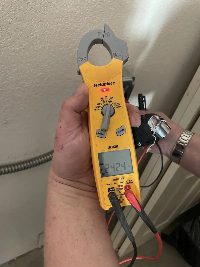 Voltage testing with clamp meter during Ceiling Fan Installation in Elsa
